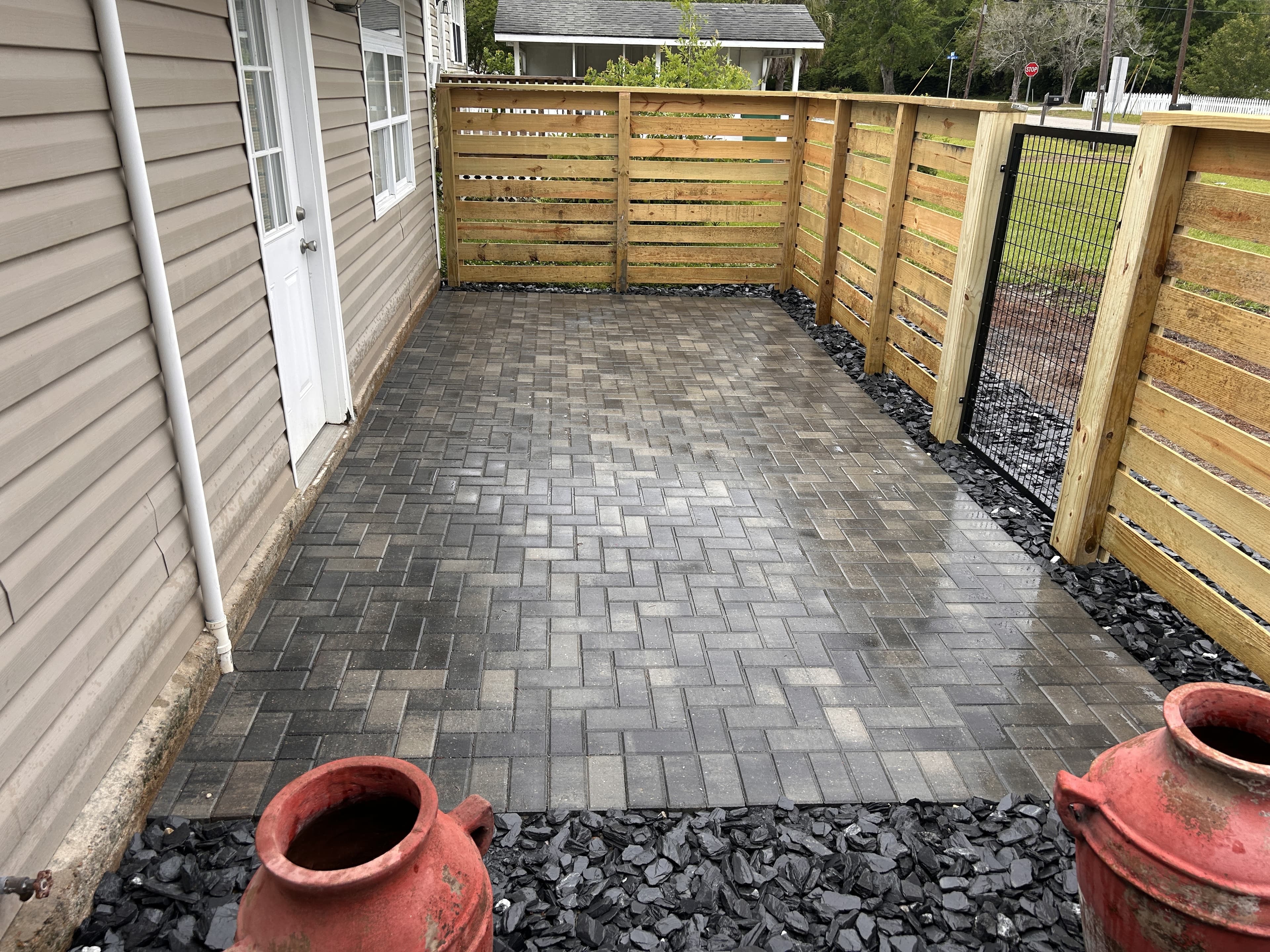 Holland Antique Pewter herringbone paver patio with horizontal picket fence